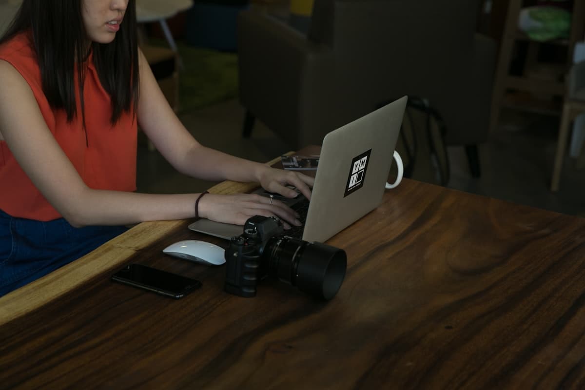 A marketer works on content creation and copywriting at a laptop in a modern office