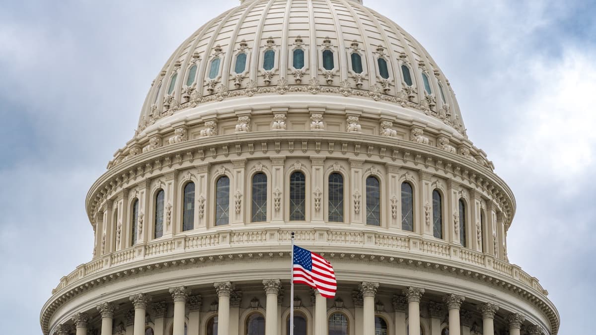 The dome of the United States Capitol under an overcast sky, representing the national institutions Gates argues should govern the AI transition rather than the companies building it
