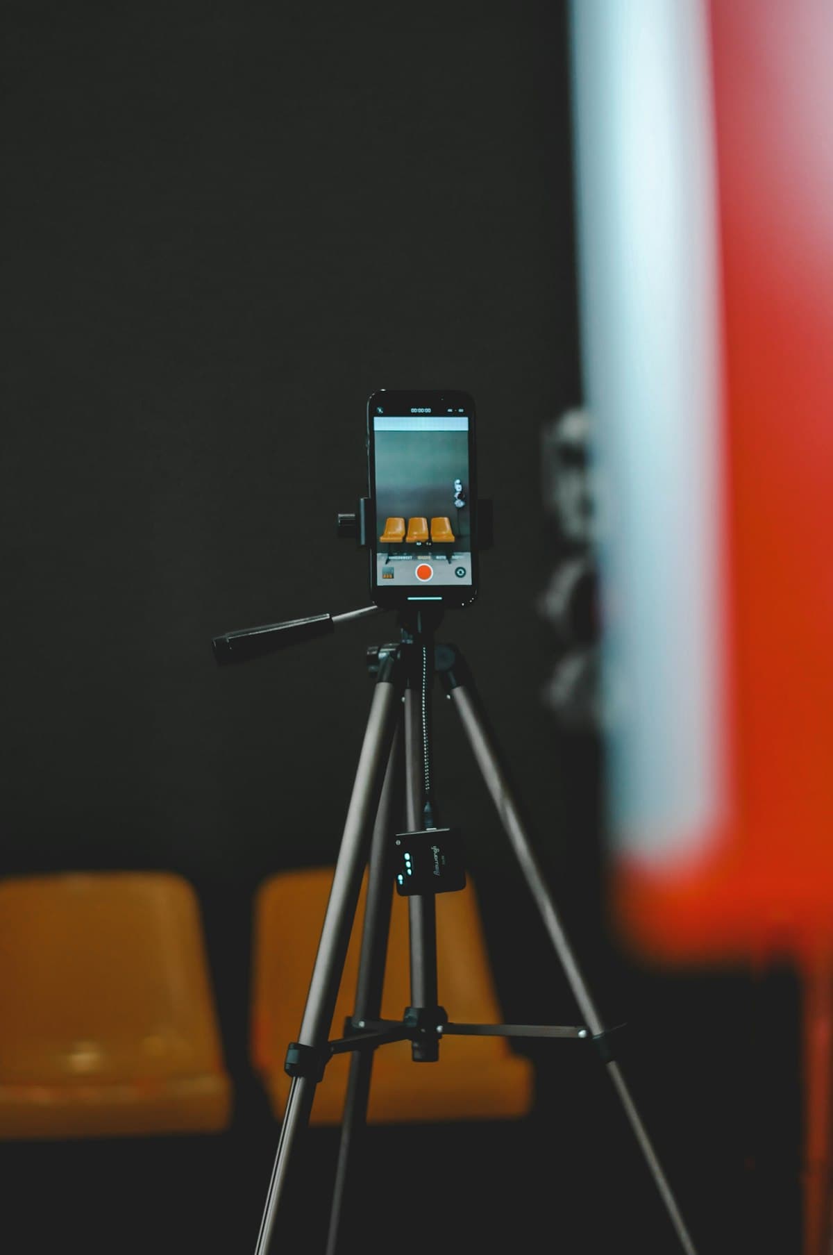 A smartphone mounted on a tripod filming a scene, illustrating simple mobile-first content capture paired with AI-generated footage