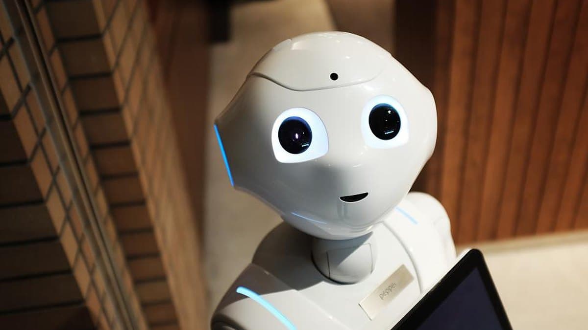 A white humanoid service robot with a screen on its chest, the class of machine Musk expects to reach a billion units